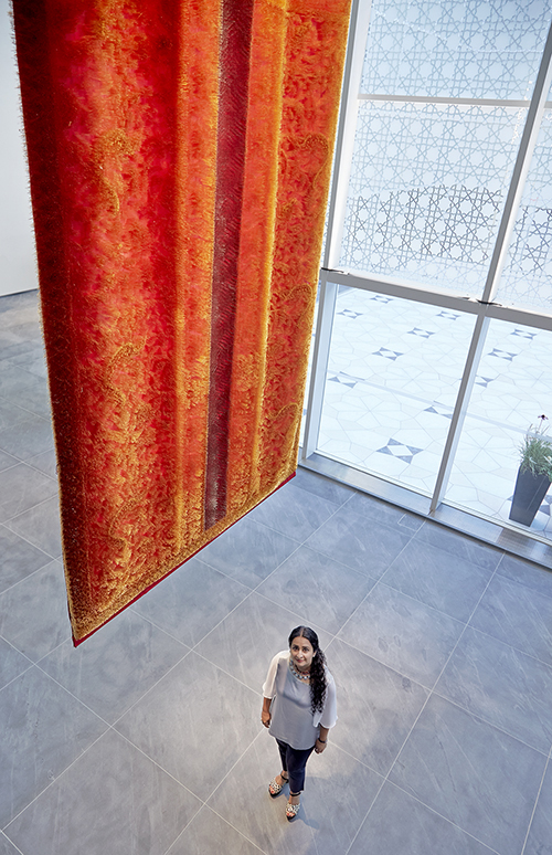 Aisha Khalid standing below AKM 2015.1.1
