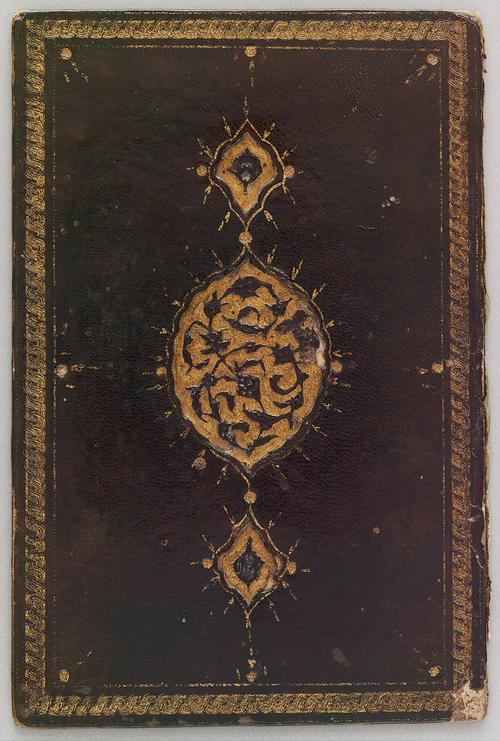 Single bookbinding cover, leather decorated with a gold boarder and a central recessed gold oval medallion with pendants, and the medallion is filled with a stamped design of flowers and leaves on curving branches.