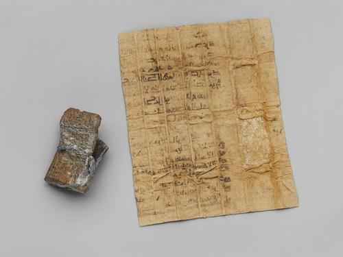 Back view of the lead case and once folded piece of paper that fit inside.