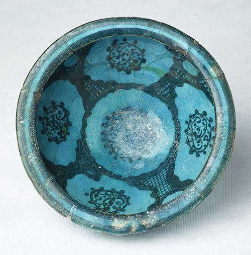 Footed bowl, fritted body, painted in black under turquoise glaze.