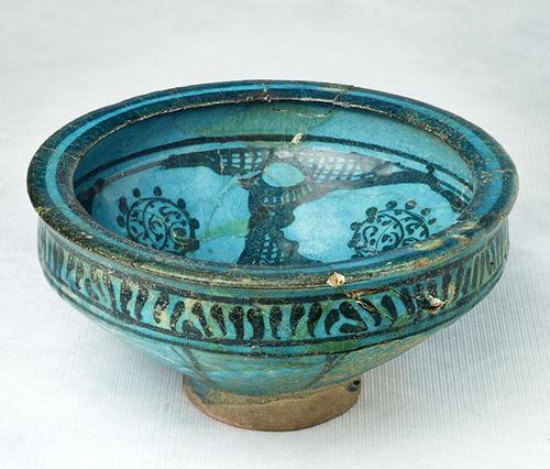 Footed bowl, fritted body, painted in black under turquoise glaze.