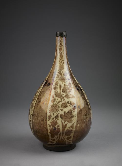 Lustre bottle, decorated in brown against a cream-coloured background. On the exterior, the surface is divided into four panels of foliate decoration separated by four massive cypress trees.