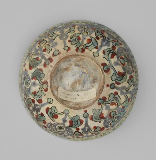 Bottom of ceramic bowl decorated with floral designs.