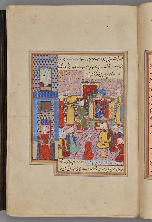 Painting within a rectangular border of blue, gold, red, and green, with script inside the top and bottom border. The prince is seated on a platform with figures standing and sitting beside him. An audience kneels in front of him on a carpet.   