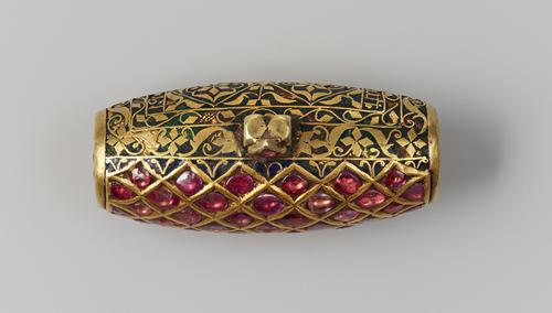 Top view of Cylindrically-shaped pendant, can see both sides, rubies on one side and green enamel on the other.