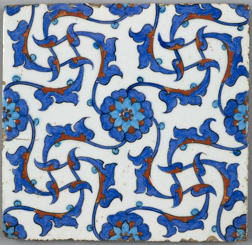 Ceramic, square tile, decorated with a central rosette radiating a geometric pattern of arabesques, painted in red, turquoise and cobalt-blue against an opaque-white ground.   