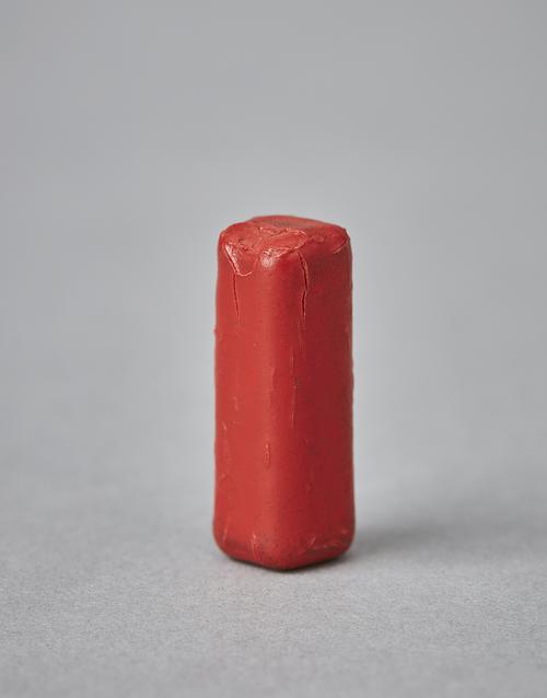 Red piece of wax.